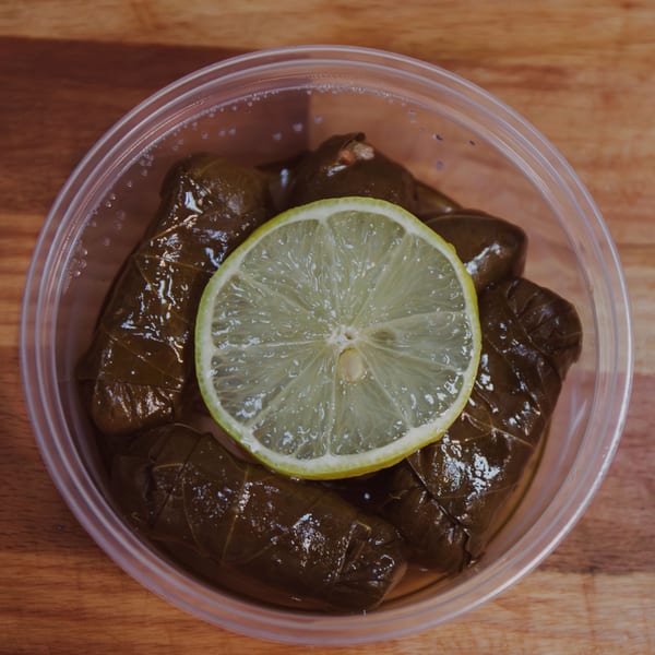 Mozillas Kitchen's Mediterranean dolmades, grape leaves stuffed with rice, topped with a lemon slice.