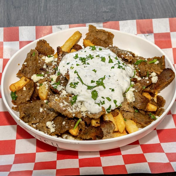 Mozillas Kitchen's Mediterranean gyro fries, topped with tzatziki sauce, feta cheese, and parsley.